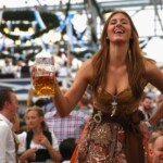 MUNICH, GERMANY - SEPTEMBER 20: A reveller dressed in traditional Bavarian clothing `Dirndl` holds a beer mug at Schottenhamel beer tent at the opening day of the 2014 Oktoberfest at Theresienwiese on September 20, 2014 in Munich, Germany. The 181st Oktoberfest will be open to the public from September 20 through October 5 and traditionally draws millions of visitors from across the globe in the world's largest beer fest. (Photo by Alexander Hassenstein/Getty Images)