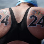 You will get 24 hard smacks on each wet cheek with my bare and wet hand. Right now here at the pool on the starting block and before hundreds of spectators. Trunks down and over my knee now.
